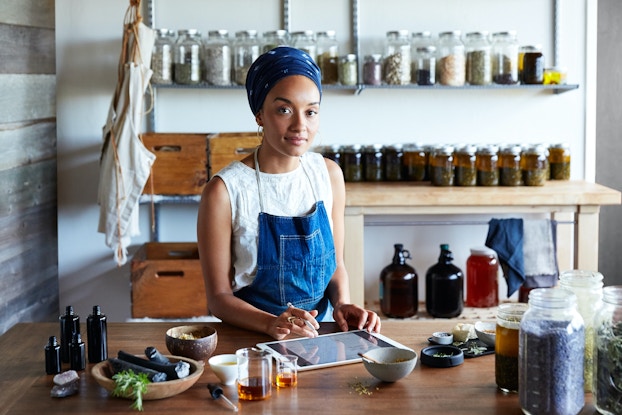 Small business owner standing inside her shop.