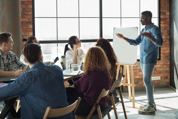 boss presenting to team of employees