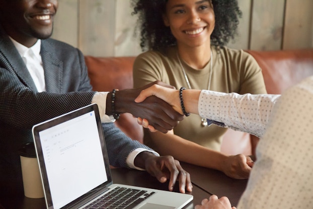 Business lender shaking hands with entrepreneur