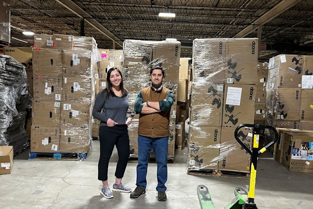 An image of Kidsy Co-Founders Shraysi Tandon and Sinan Sari pictured in their warehouse.