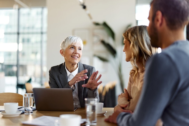 Two people meeting with a banking specialist.