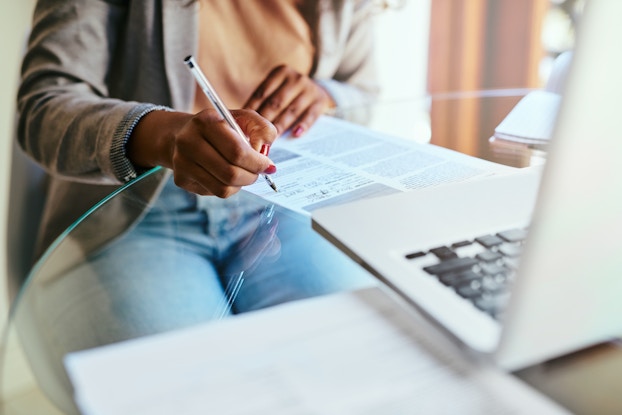 woman filling out paperwork