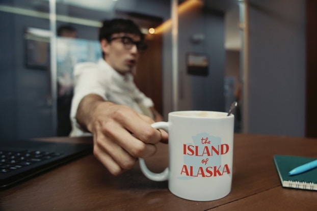 Person holding a personalized mug created on Shutterfly.
