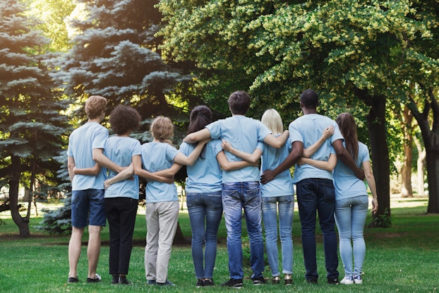 group of volunteers with their arms around each other